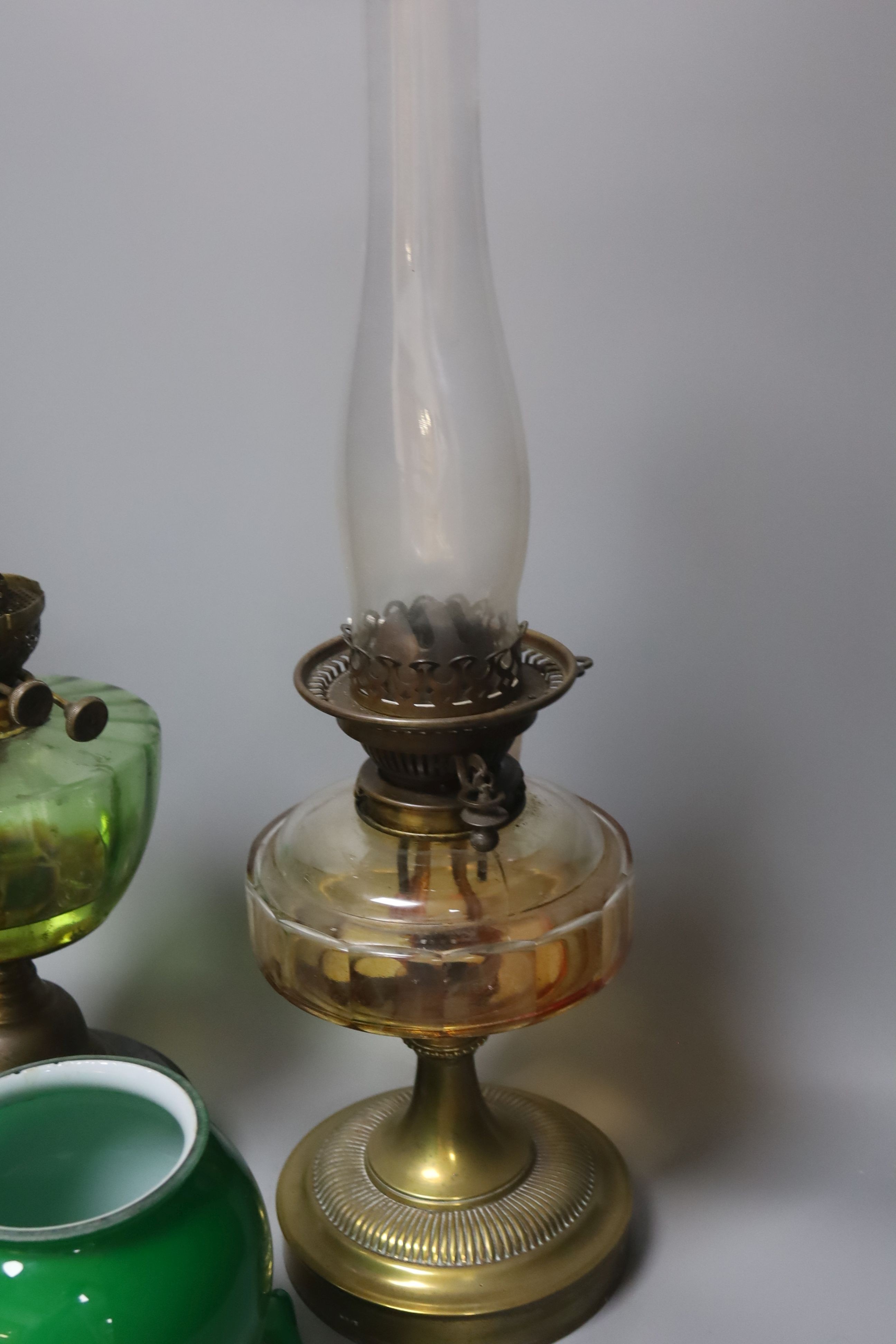 A brass green shade oil lamp and another oil lamp, 53cm